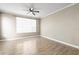 Spacious bedroom with wood-look floors and a large window for natural light at 9842 Lake Chase Island Way, Tampa, FL 33626