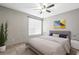 A bright bedroom with a large window, a ceiling fan, a queen-sized bed, and minimalist decor at 9842 Lake Chase Island Way, Tampa, FL 33626