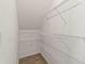 Walk-in closet has built in wire rack shelving and base trim at 9842 Lake Chase Island Way, Tampa, FL 33626