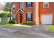Beautiful townhome with a private garage and a lush green lawn at 9842 Lake Chase Island Way, Tampa, FL 33626