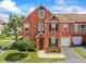 Charming townhome showcasing a well-maintained exterior with beautiful landscaping at 9842 Lake Chase Island Way, Tampa, FL 33626