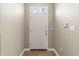 Bright foyer featuring a decorative window above the front door and wood-look flooring at 9842 Lake Chase Island Way, Tampa, FL 33626