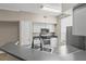 Modern kitchen featuring gray countertops, stainless steel appliances, and ample cabinet space at 9842 Lake Chase Island Way, Tampa, FL 33626