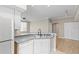 Bright kitchen features modern appliances, light gray countertops, and stainless steel sink at 9842 Lake Chase Island Way, Tampa, FL 33626