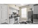 Well-lit kitchen with gray countertops and a stainless steel oven and appliances at 9842 Lake Chase Island Way, Tampa, FL 33626
