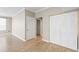 Open living room features hardwood floors, fresh paint, and a closet for storage at 9842 Lake Chase Island Way, Tampa, FL 33626