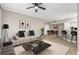This spacious living room features a modern sectional sofa, ceiling fan and open layout to the dining and kitchen area at 9842 Lake Chase Island Way, Tampa, FL 33626