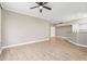 Bright living room with wood-look floors, a ceiling fan, and recessed lighting at 9842 Lake Chase Island Way, Tampa, FL 33626