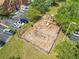 Aerial view of community playground featuring slides and swings, perfect for Gathering fun at 9842 Lake Chase Island Way, Tampa, FL 33626