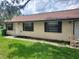 A cozy single-story home featuring a well-kept lawn and traditional window shutters at 9902 N Myrtle St, Tampa, FL 33617