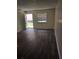 Bright living room featuring sleek floors, a large window, and an open entryway at 9902 N Myrtle St, Tampa, FL 33617