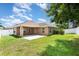 Expansive backyard featuring lush lawn, patio, and white vinyl fence at 10847 Kirkwall Port Dr, Wimauma, FL 33598