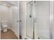Bright bathroom with modern shower stall featuring glass doors and tile floors at 10847 Kirkwall Port Dr, Wimauma, FL 33598