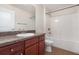 Well-lit bathroom featuring granite vanity and a shower-tub combo at 10847 Kirkwall Port Dr, Wimauma, FL 33598