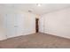 Carpeted bedroom with double door closet at 10847 Kirkwall Port Dr, Wimauma, FL 33598