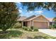 A well landscaped single story home with a two car garage and stone details at 10847 Kirkwall Port Dr, Wimauma, FL 33598