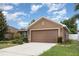 A well maintained single story home with a two car garage and a long driveway at 10847 Kirkwall Port Dr, Wimauma, FL 33598