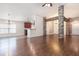 Bright open-concept living area featuring hardwood floors and decorative stone and wood beam elements at 10847 Kirkwall Port Dr, Wimauma, FL 33598