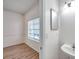 Bathroom with a pedestal sink adjacent to the dining area and a windowed room at 113 S Sherrill St # 113, Tampa, FL 33609