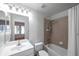 Bathroom featuring sink, toilet, bathtub with shower and tiled walls at 113 S Sherrill St # 113, Tampa, FL 33609