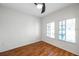 Bedroom features hardwood floors, two windows, and a ceiling fan at 113 S Sherrill St # 113, Tampa, FL 33609