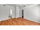 Spacious bedroom with wood floors, bathroom, and closet entrances at 113 S Sherrill St # 113, Tampa, FL 33609