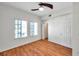 Bedroom features hardwood floors, two windows, a ceiling fan, and a door at 113 S Sherrill St # 113, Tampa, FL 33609
