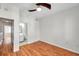 Bedroom features hardwood floors, a ceiling fan, and a door to the bathroom at 113 S Sherrill St # 113, Tampa, FL 33609