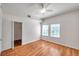 Bedroom with wood floors, closet entrance, and two windows at 113 S Sherrill St # 113, Tampa, FL 33609