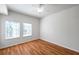 Bright bedroom featuring wood floors, ceiling fan, and two large windows at 113 S Sherrill St # 113, Tampa, FL 33609