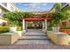 Charming courtyard with stone pavers, pergola, water feature, and lush landscaping in a tranquil setting at 113 S Sherrill St # 113, Tampa, FL 33609