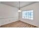 Dining area features wood-look floors, a pendant light fixture, and a large window at 113 S Sherrill St # 113, Tampa, FL 33609