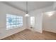 Dining area featuring wood-look floors, a window, and access to an adjacent bathroom at 113 S Sherrill St # 113, Tampa, FL 33609