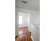 Hallway with wooden floor leads to a room with a window at 113 S Sherrill St # 113, Tampa, FL 33609