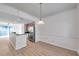 Bright kitchen featuring stainless steel appliances and wood-look floors adjacent to the dining area at 113 S Sherrill St # 113, Tampa, FL 33609