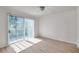 Spacious living room with wood-look floors, a ceiling fan, and a sliding glass door at 113 S Sherrill St # 113, Tampa, FL 33609