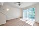 Bright living room featuring wood-look floors, a ceiling fan, and a sliding glass door at 113 S Sherrill St # 113, Tampa, FL 33609