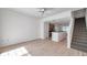 Spacious living room featuring hardwood floors and staircase access at 113 S Sherrill St # 113, Tampa, FL 33609
