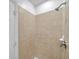Bathroom shower area with neutral tile, handheld shower, and built in soap dish at 113 S Sherrill St # 113, Tampa, FL 33609