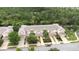 Aerial view of townhomes with private driveways, well-maintained landscaping, and community playground at 11546 52Nd E Ct, Parrish, FL 34219