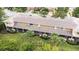 Back view of townhomes showcasing screened patios, lush greenery, and community landscaping at 11546 52Nd E Ct, Parrish, FL 34219