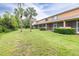 Backyard featuring screened-in patios, well-maintained grass, and trees, perfect for outdoor activities and relaxation at 11546 52Nd E Ct, Parrish, FL 34219