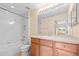 Well-lit bathroom featuring a shower-tub combo and a wood vanity with a white countertop and sink at 11546 52Nd E Ct, Parrish, FL 34219