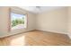 Well-lit bedroom with wood flooring, a ceiling fan and a bright window view to the outside at 11546 52Nd E Ct, Parrish, FL 34219