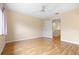 Spacious bedroom with light colored walls, wood floors, and access to other rooms at 11546 52Nd E Ct, Parrish, FL 34219
