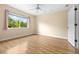Sunlit bedroom featuring wood flooring and a window framing picturesque outdoor views at 11546 52Nd E Ct, Parrish, FL 34219