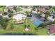 Aerial view showcasing community pool, tennis and basketball courts, playground and lush landscaping at 11546 52Nd E Ct, Parrish, FL 34219