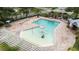 Aerial view of a community pool with a playful splash fountain and lounging area surrounded by palm trees at 11546 52Nd E Ct, Parrish, FL 34219