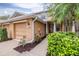 Inviting exterior of a two-story home with a well-manicured lawn, beautiful shrubs, and a palm tree at 11546 52Nd E Ct, Parrish, FL 34219
