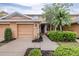 Inviting exterior of a two-story home with a well-manicured lawn, beautiful shrubs, and a palm tree at 11546 52Nd E Ct, Parrish, FL 34219
